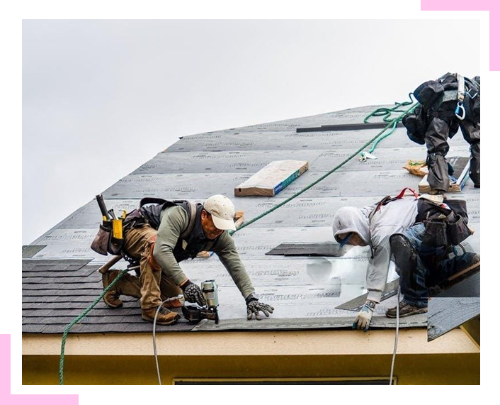 A group of men are working on a roof.