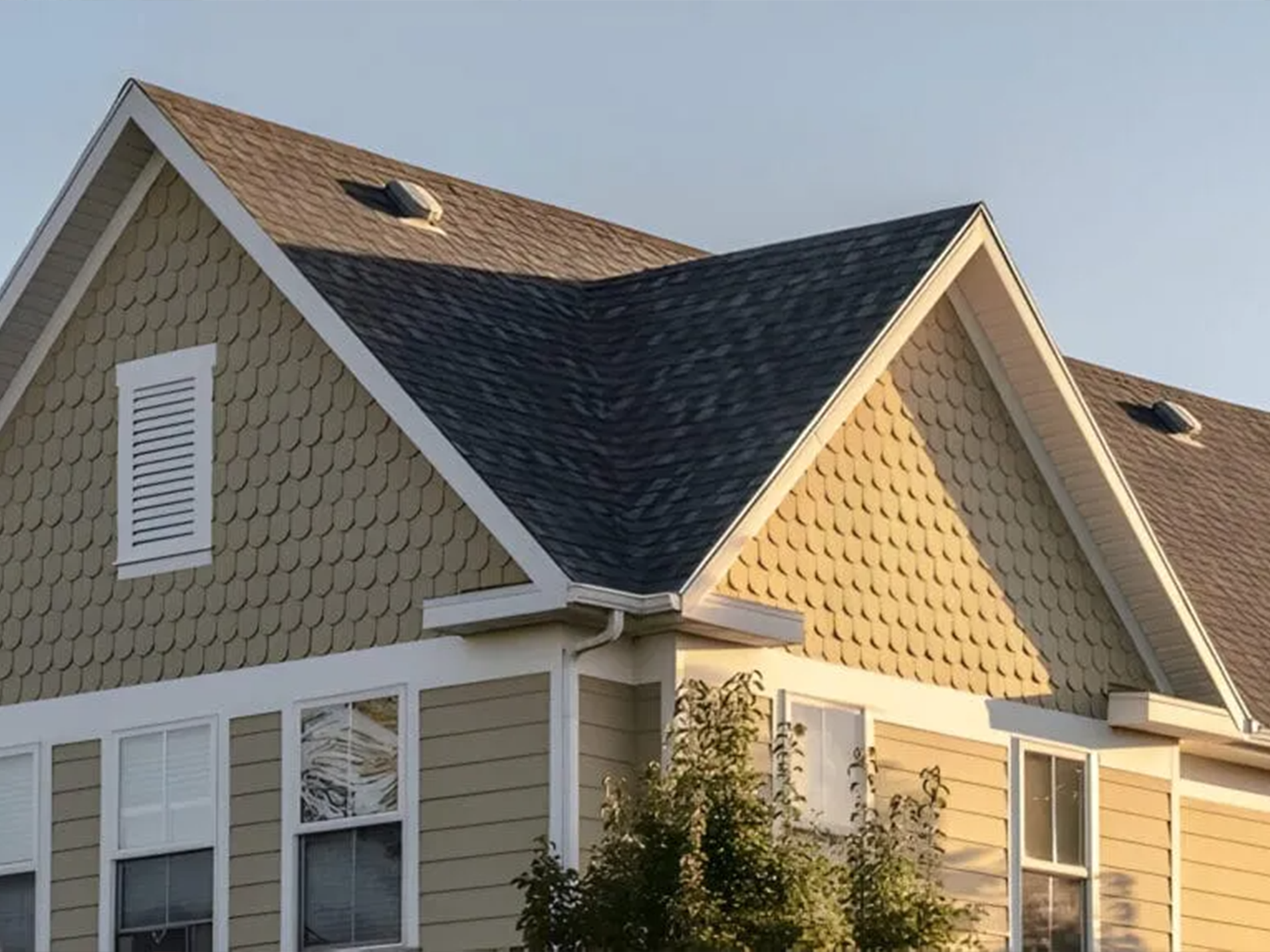 A house with a triangle shaped roof and a lot of windows