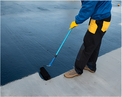 A person is painting a concrete surface with a roller.
