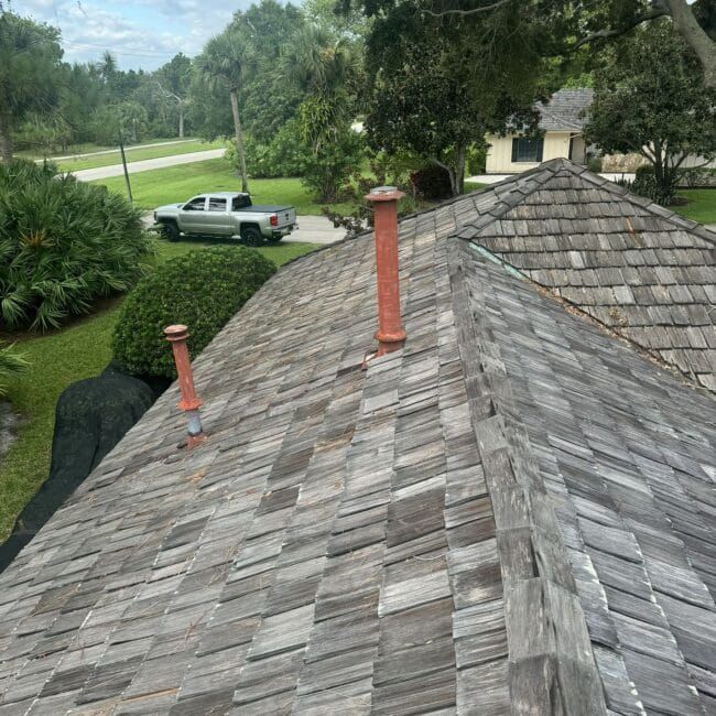 A truck is parked on the roof of a house.