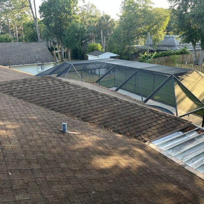 A roof of a house with a screened in area