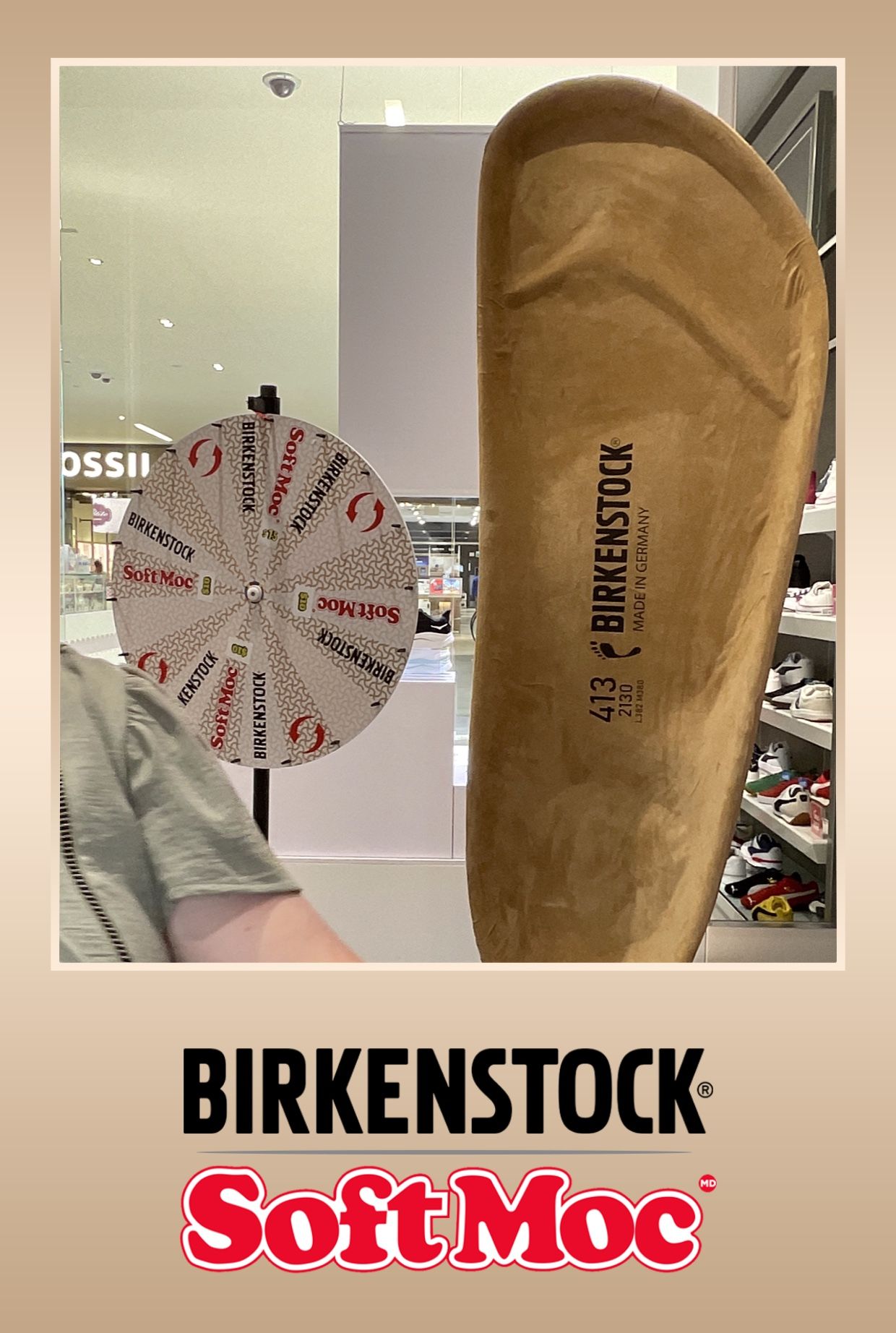 Birkenstock branded promotional image with a prize wheel and a shoe insole in a store.