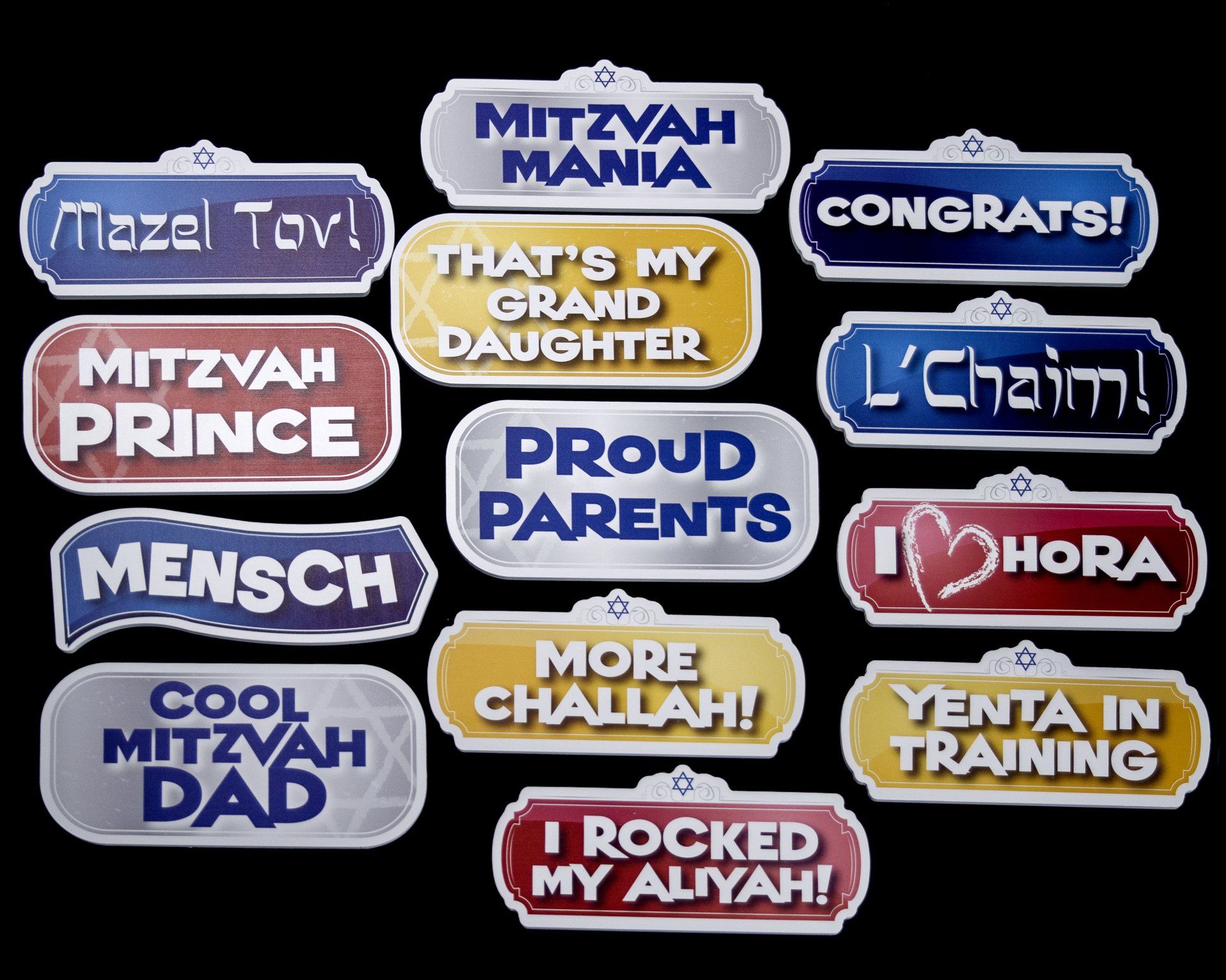 Photo booth props with Mitzvah-themed phrases in various colors, including 
