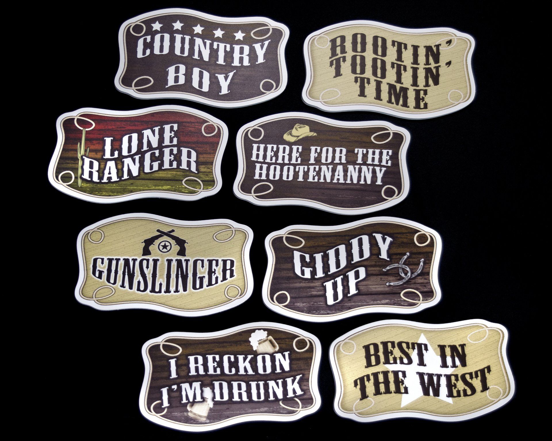 Collection of Western-themed belt buckles, each with a different phrase like 