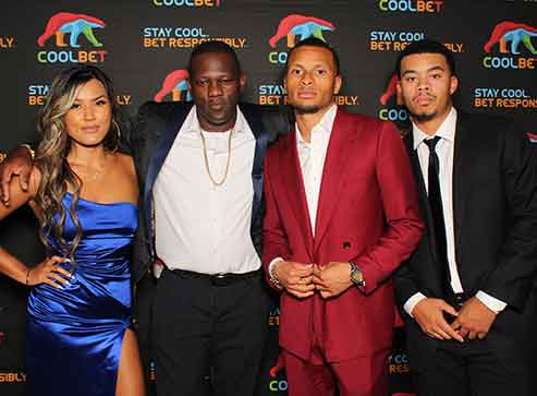 Four people pose for a photo at a 