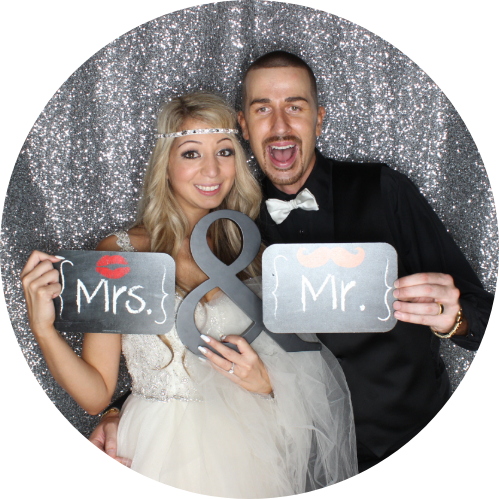 Couple in photo booth holding 
