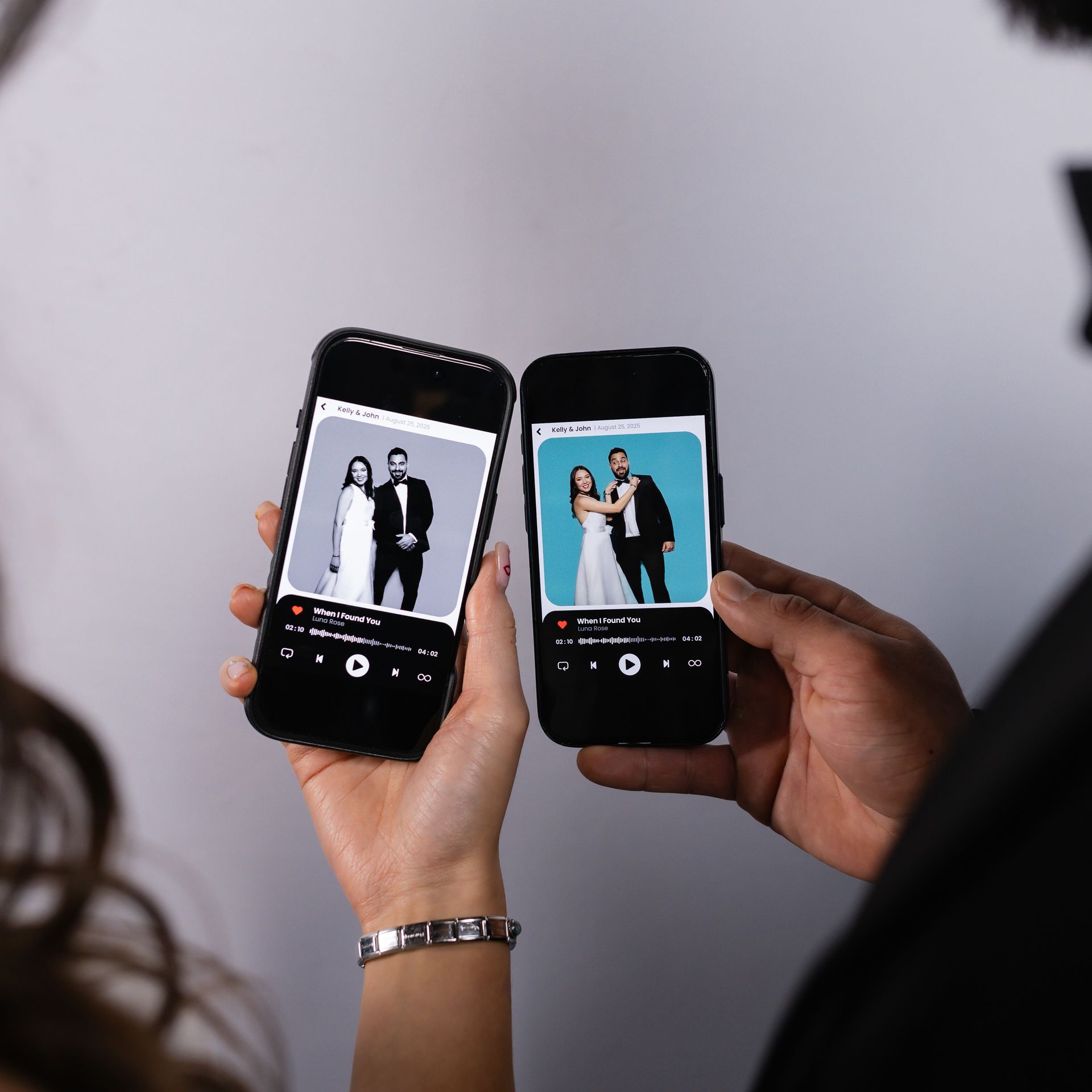 Two smartphones displaying wedding photos, held by people.