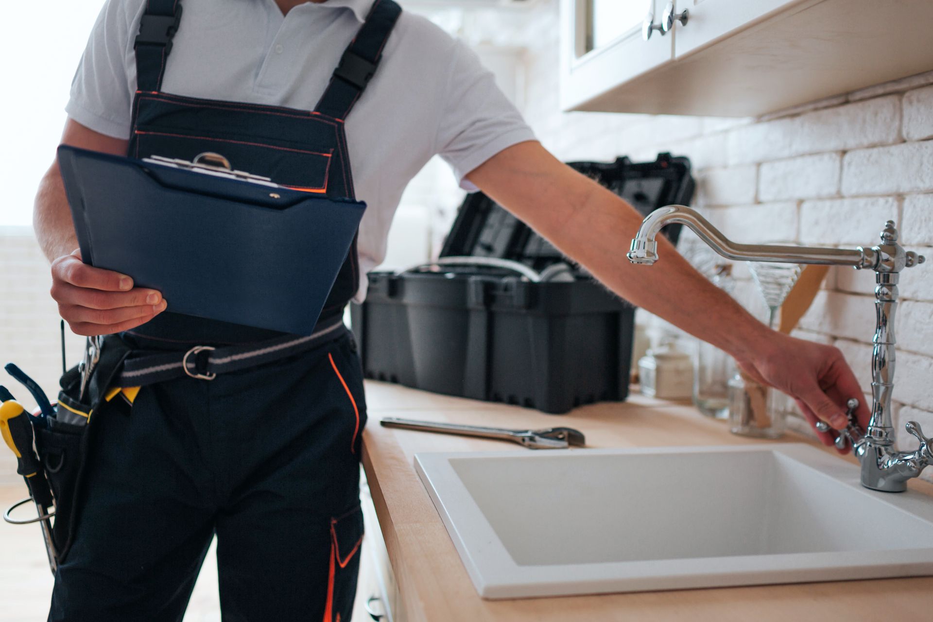 Person with arm sling reaching for a kitchen faucet beside a sink Person with arm sling reaching for a kitchen faucet beside a sink
