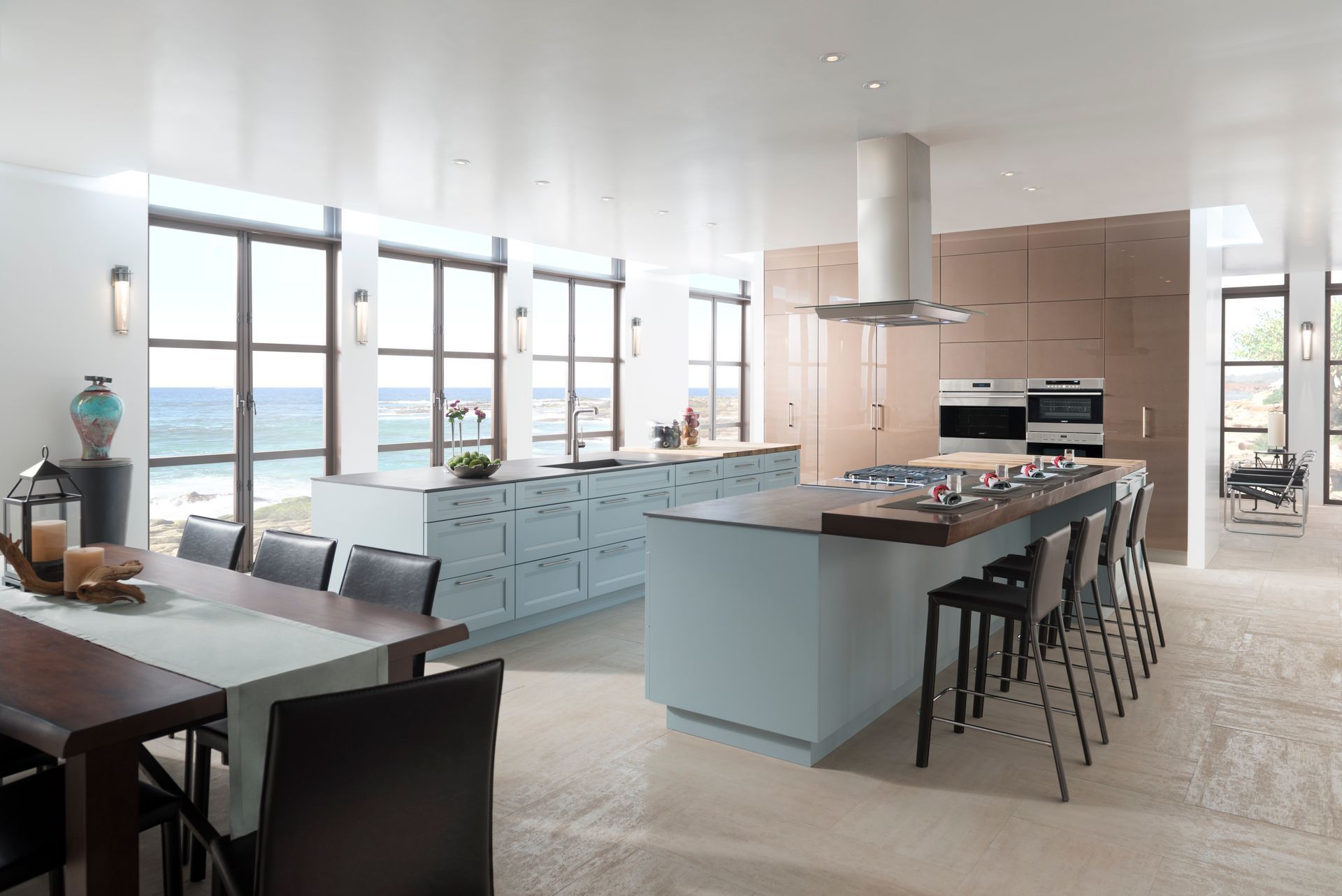 Modern kitchen with black countertop, wood cabinets, hanging lights, and three stools at a breakfast bar
