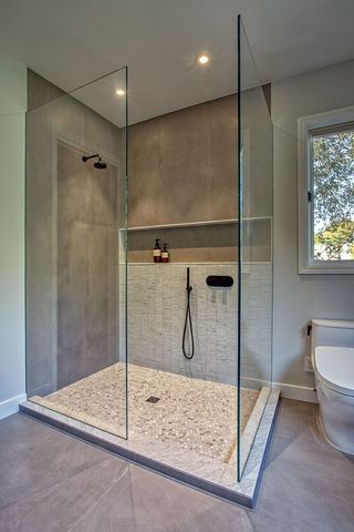 Modern bathroom with bathtub, toilet, and gold vessel sink on wooden vanity