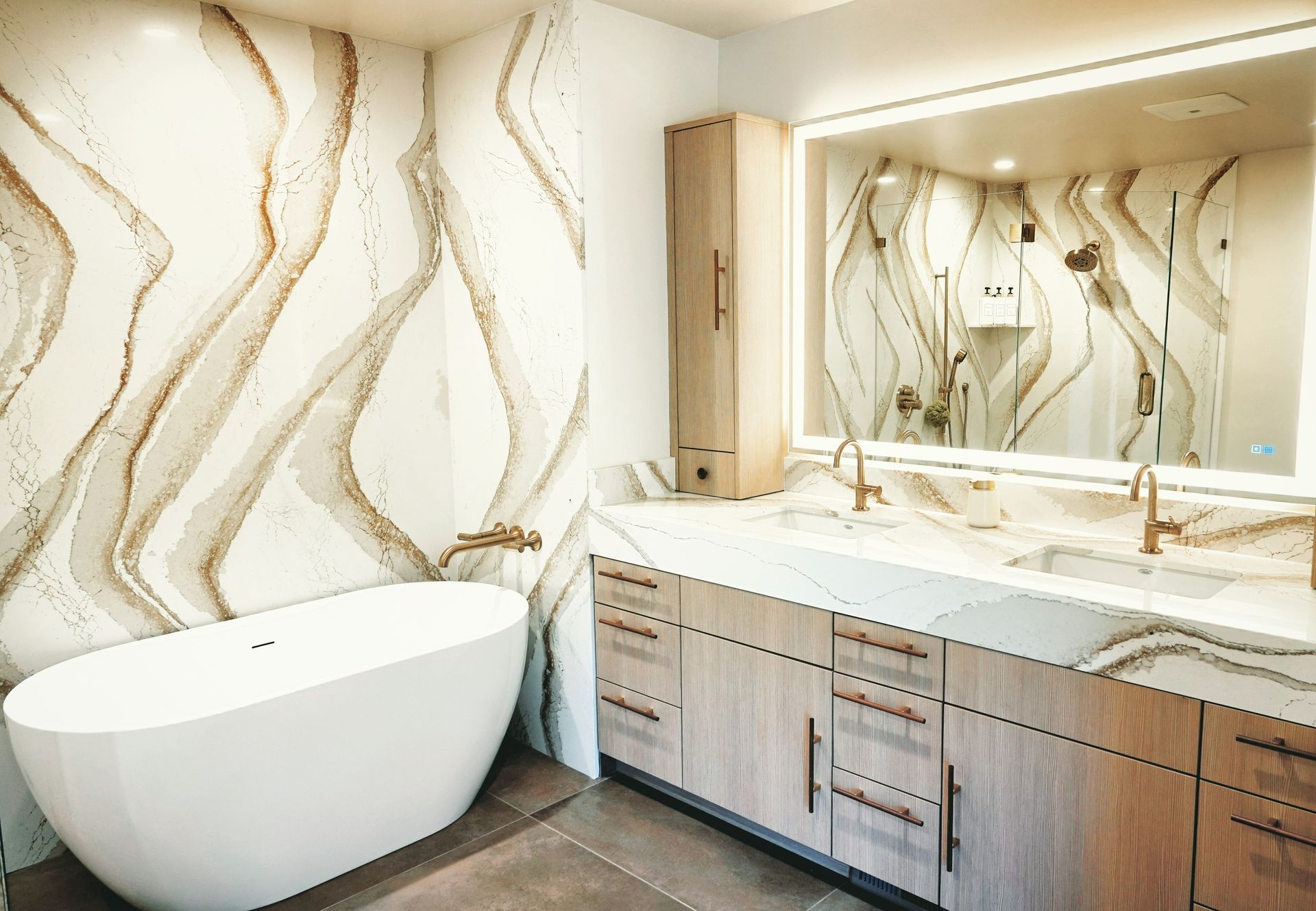 Modern bathroom with a freestanding tub, double vanity, and wavy gold-patterned wall tiles