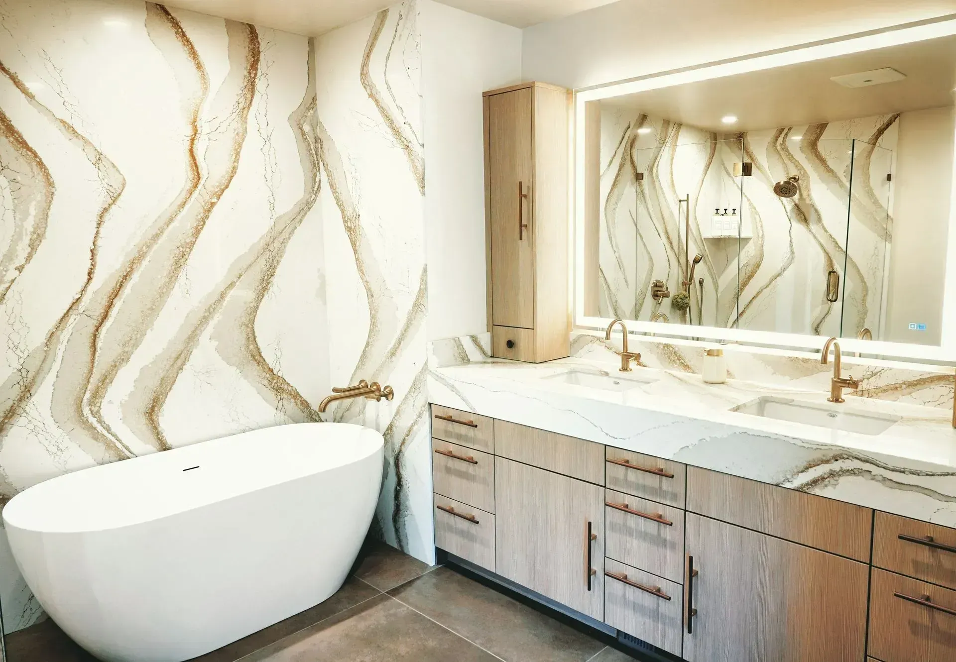 Modern bathroom with a freestanding tub, double vanity, and wavy gold-patterned wall tiles
