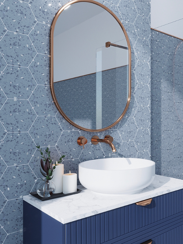 Modern bathroom vanity with oval mirror, white vessel sink, blue tile wall, and marble countertop