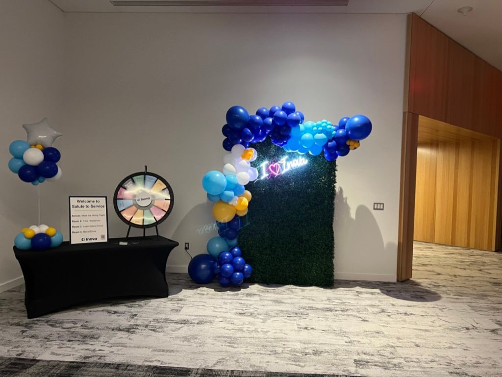 A room filled with balloons and a wheel of fortune.