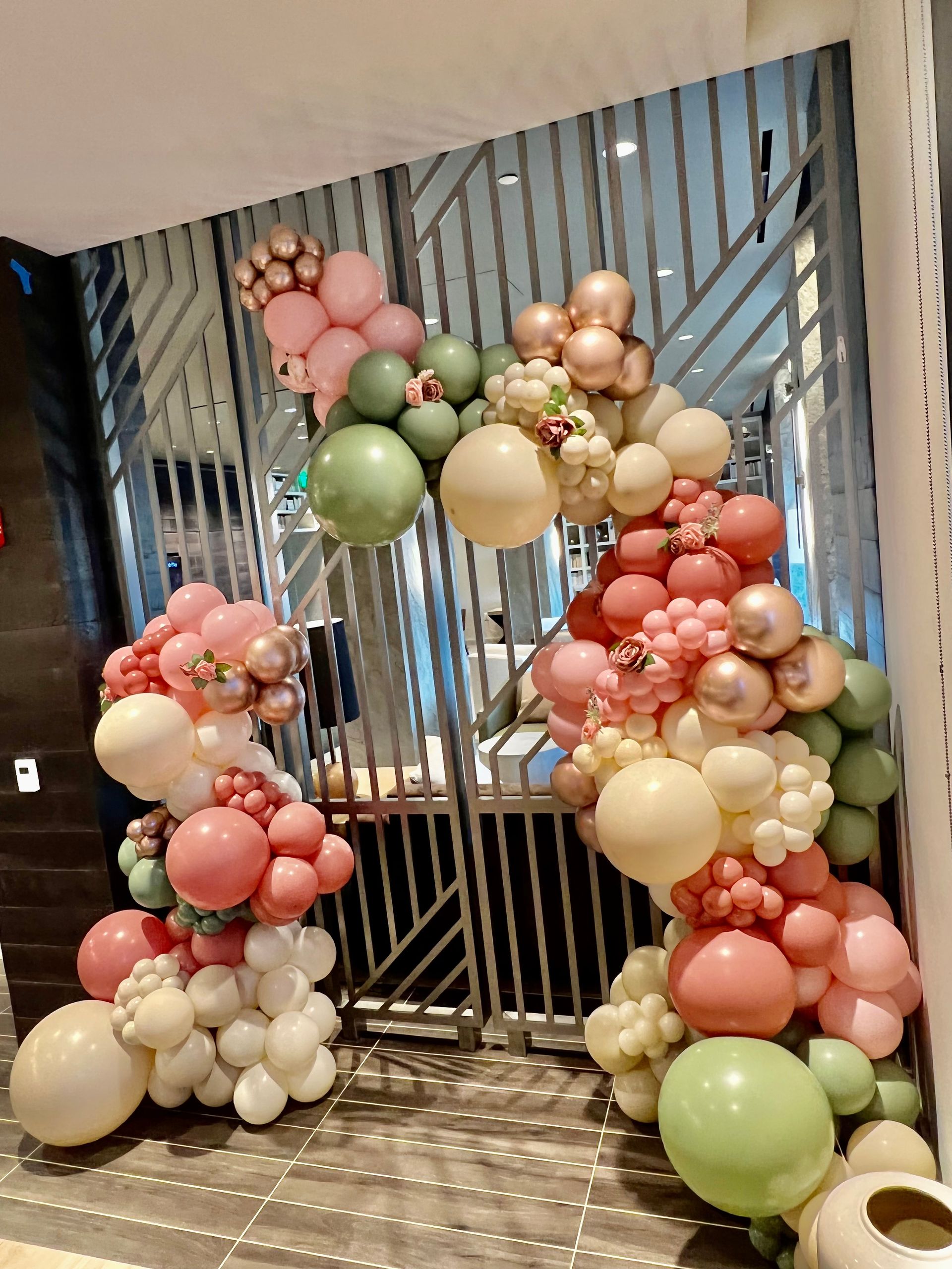 A bunch of balloons are sitting on the floor in a room.