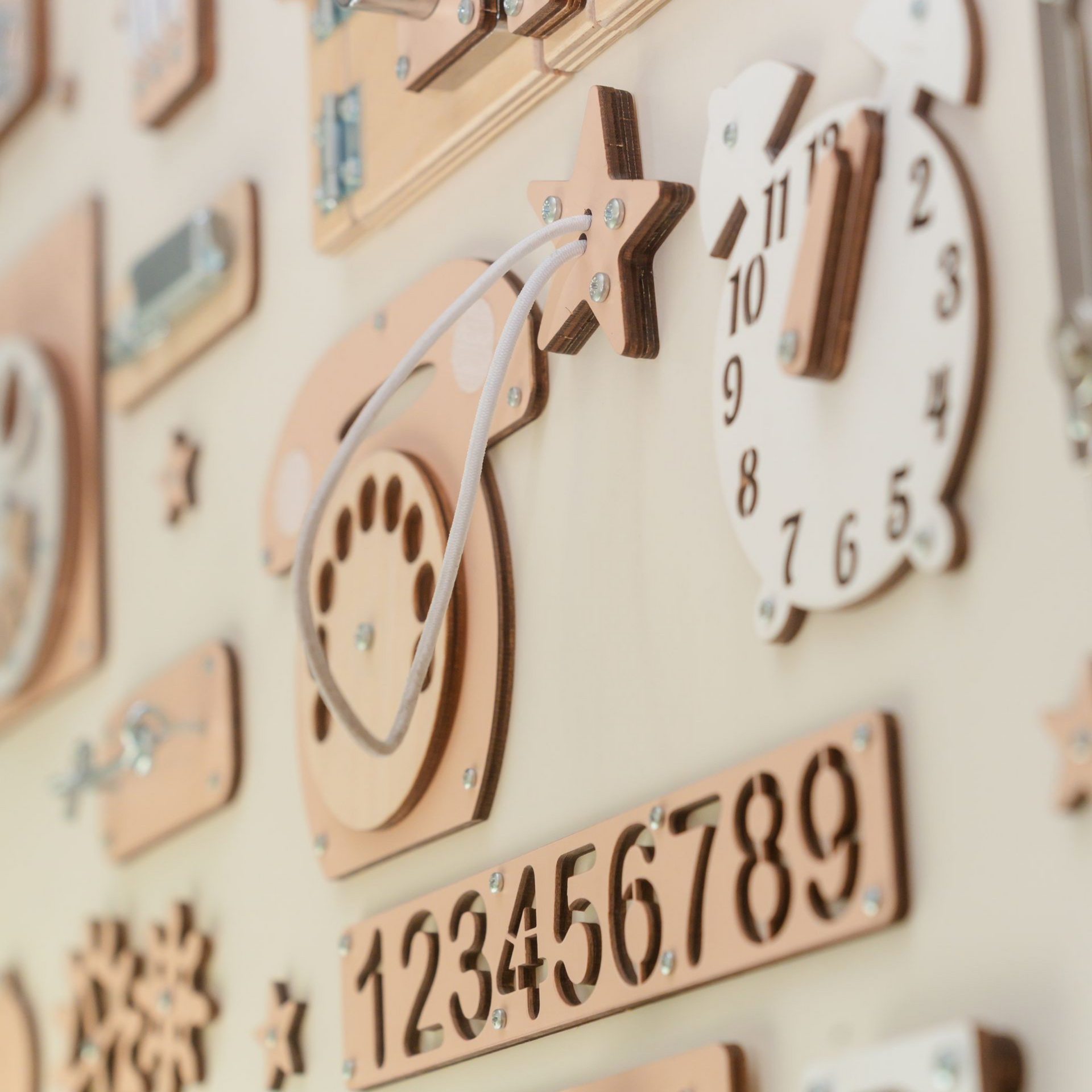 Wooden wall display with decorative clocks and numbers in soft beige tones