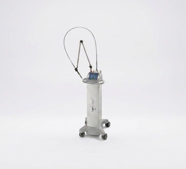 Medical device with a clear tubing loop on a white base against a plain background