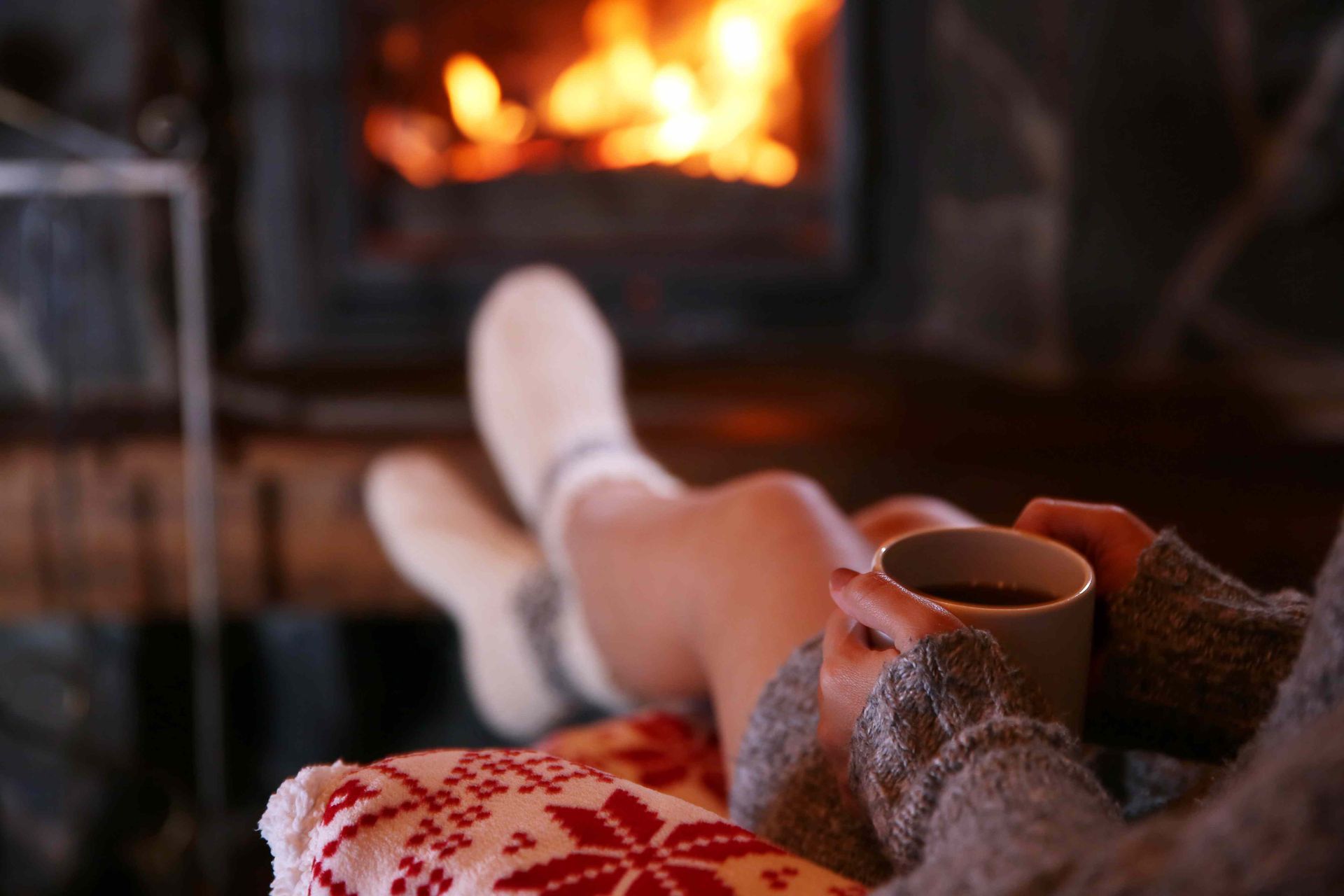 One of our customers with her feet up by a new cozy fireplace