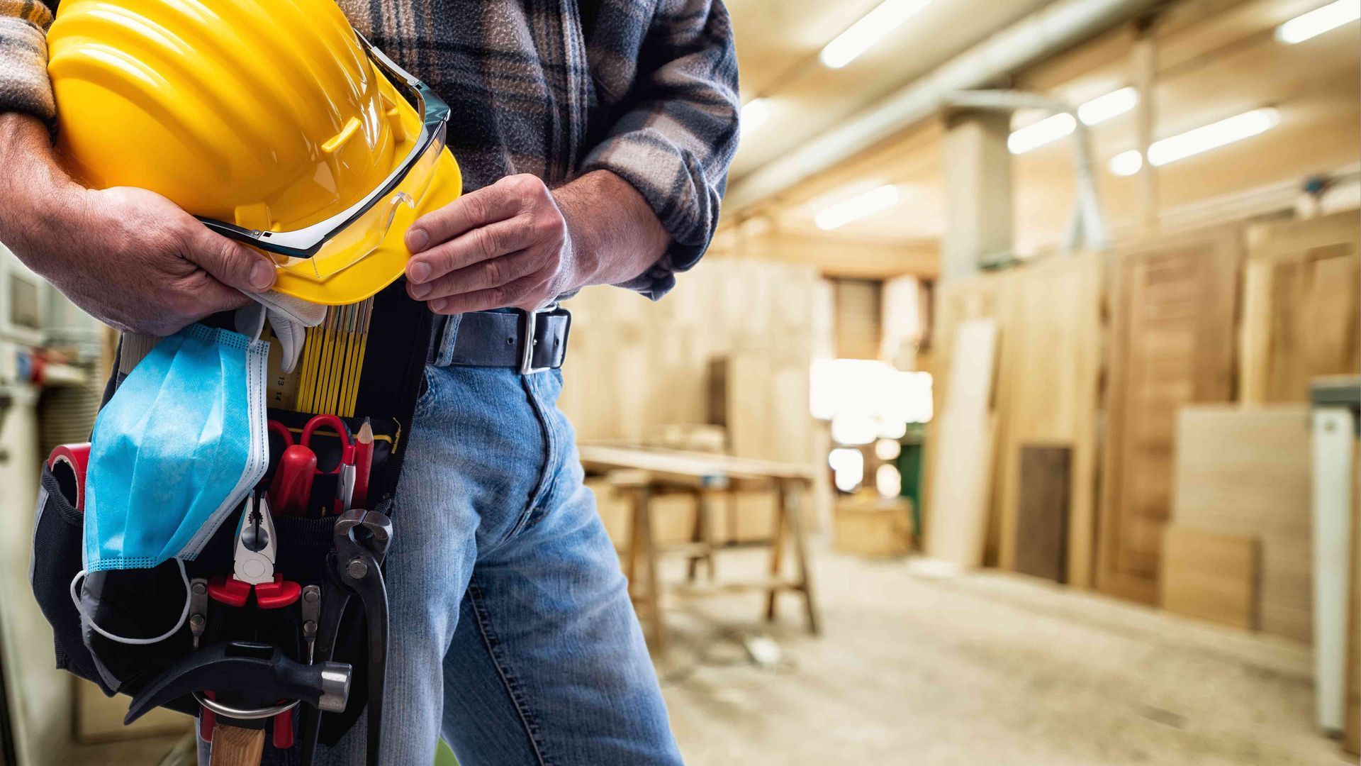 Man with hardhat standing in basement