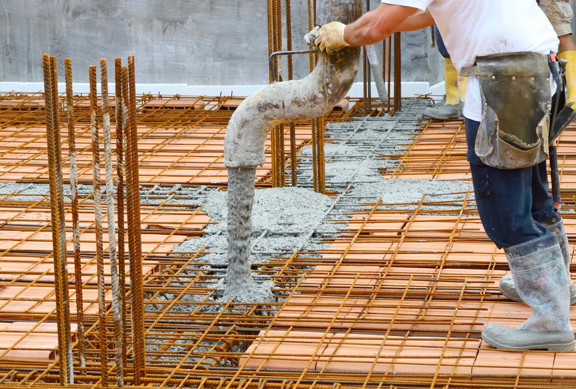 A man pouring concrete into mold