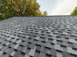 A close up of a roof with a lot of shingles on it.