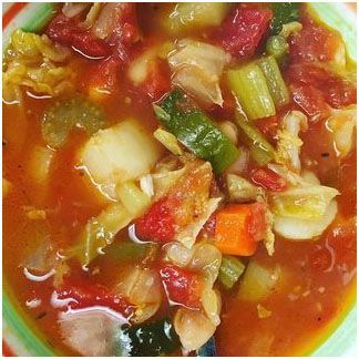 A close up of a bowl of minestrone soup