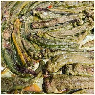 A close up of roasted long hot peppers on a plate