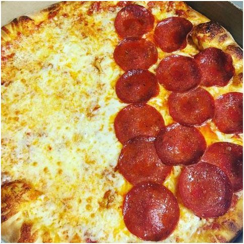 A pizza with pepperoni and cheese is in a box