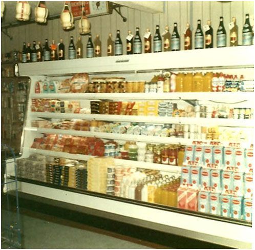 A refrigerated section of a grocery store filled with a variety of items