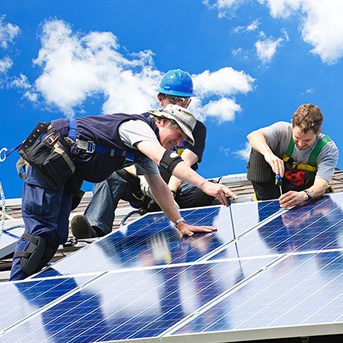 Workers Installing Solar Panels on the Roof — Ocean City, MD — Royal Plus Electric Workers Installing Solar Panels on the Roof — Ocean City, MD — Royal Plus Electric