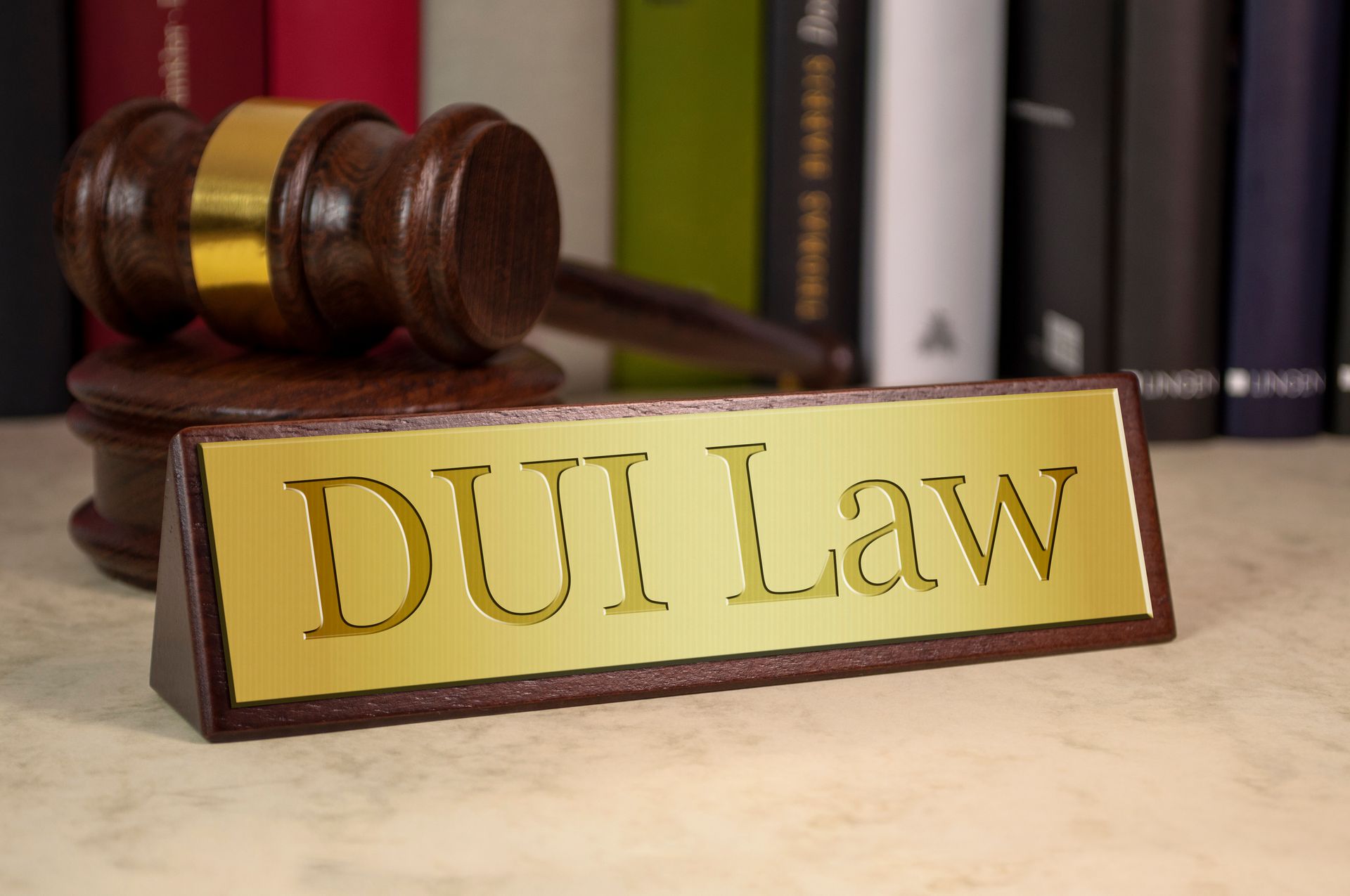 A judge’s gavel next to a desk plaque labeled “DUI Law” in an office setting. A judge’s gavel next to a desk plaque labeled “DUI Law” in an office setting.