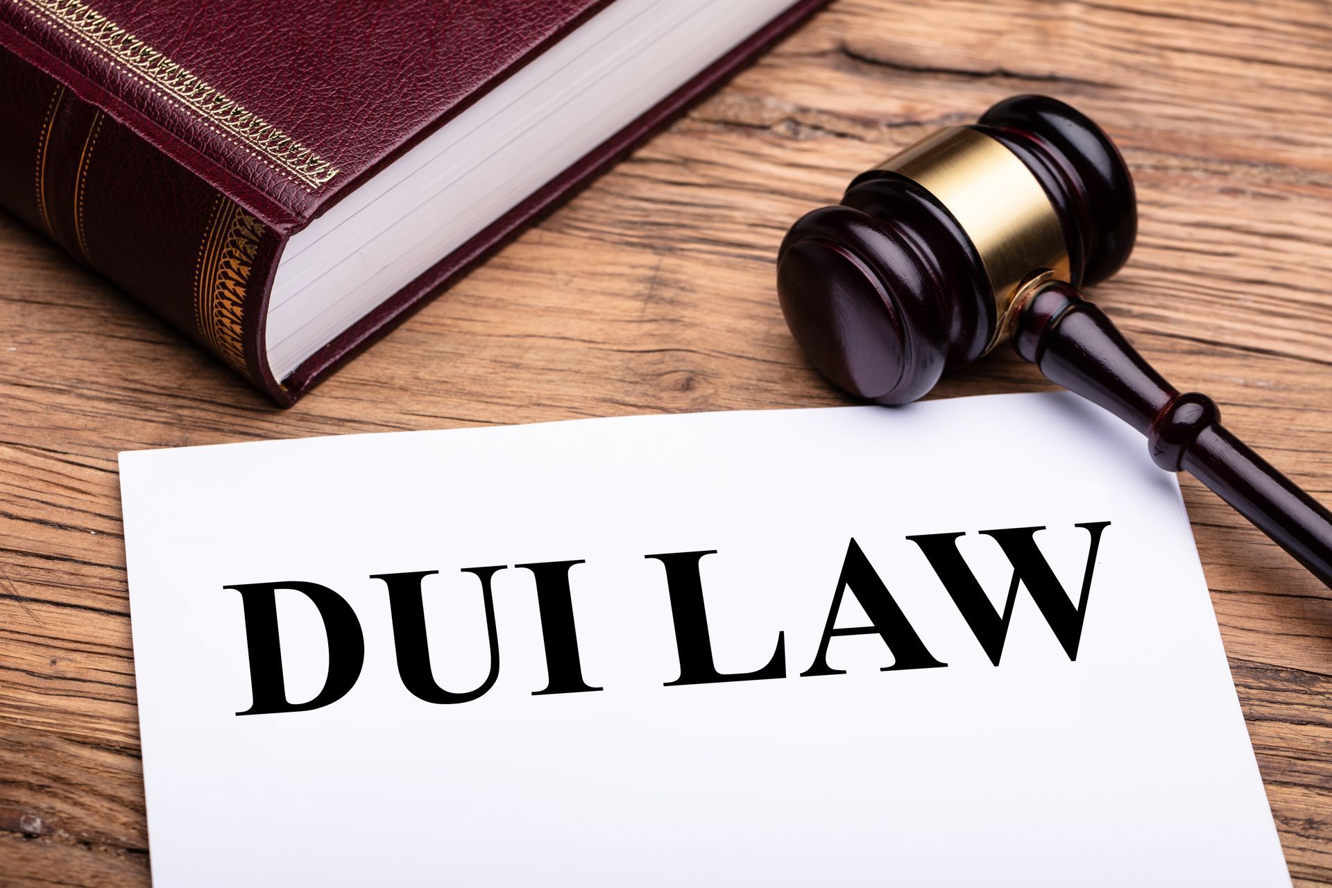 Gavel and law book beside a sign reading 