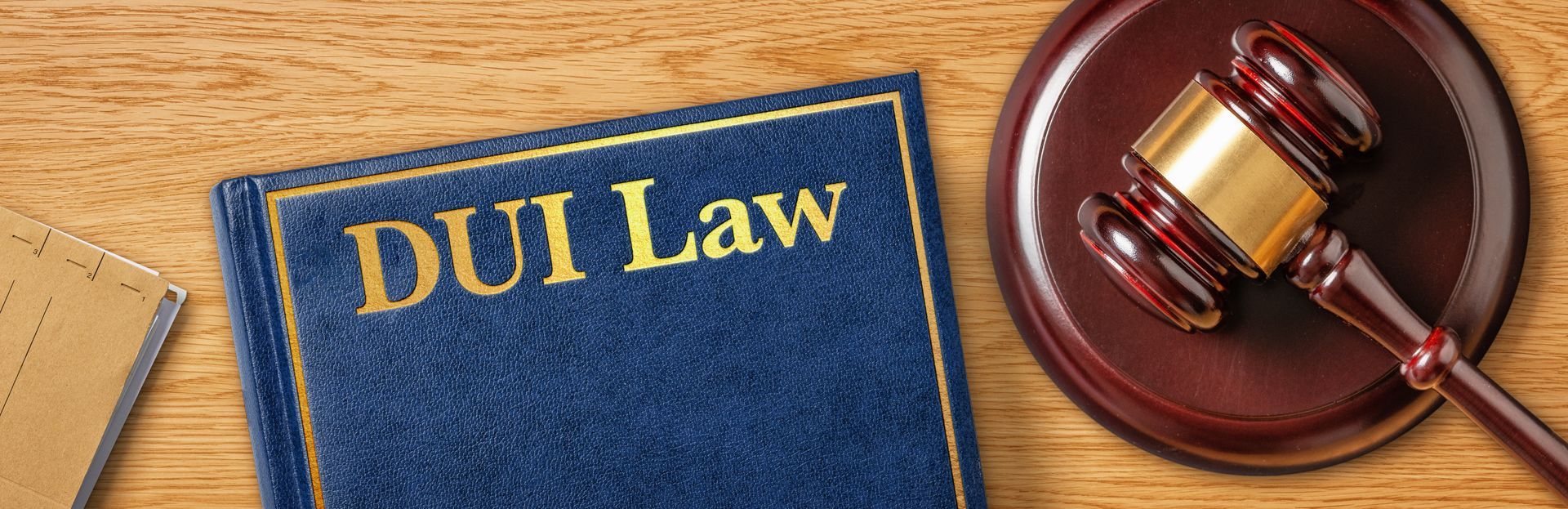 Golden sign with DUI law text and wooden gavel.