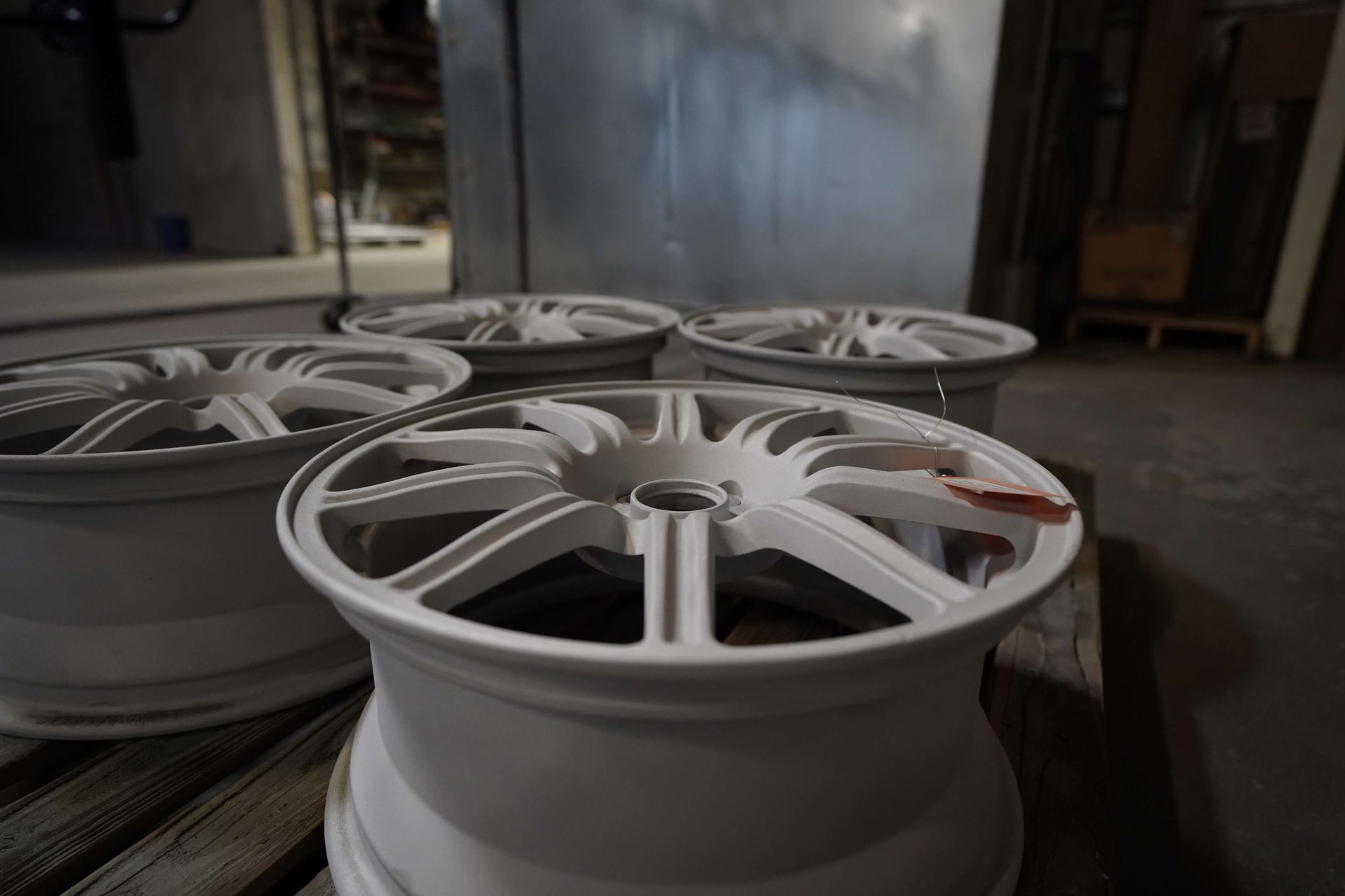 A group of white wheels are sitting on top of a wooden table.