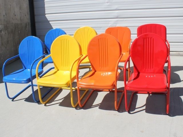 A bunch of colorful chairs are lined up in a row