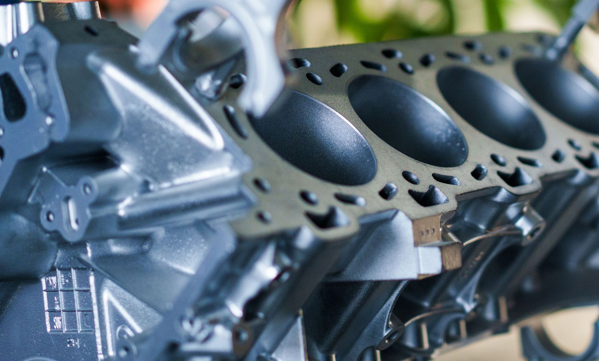 Close-up of a bare metal engine block showing the cylinder bores