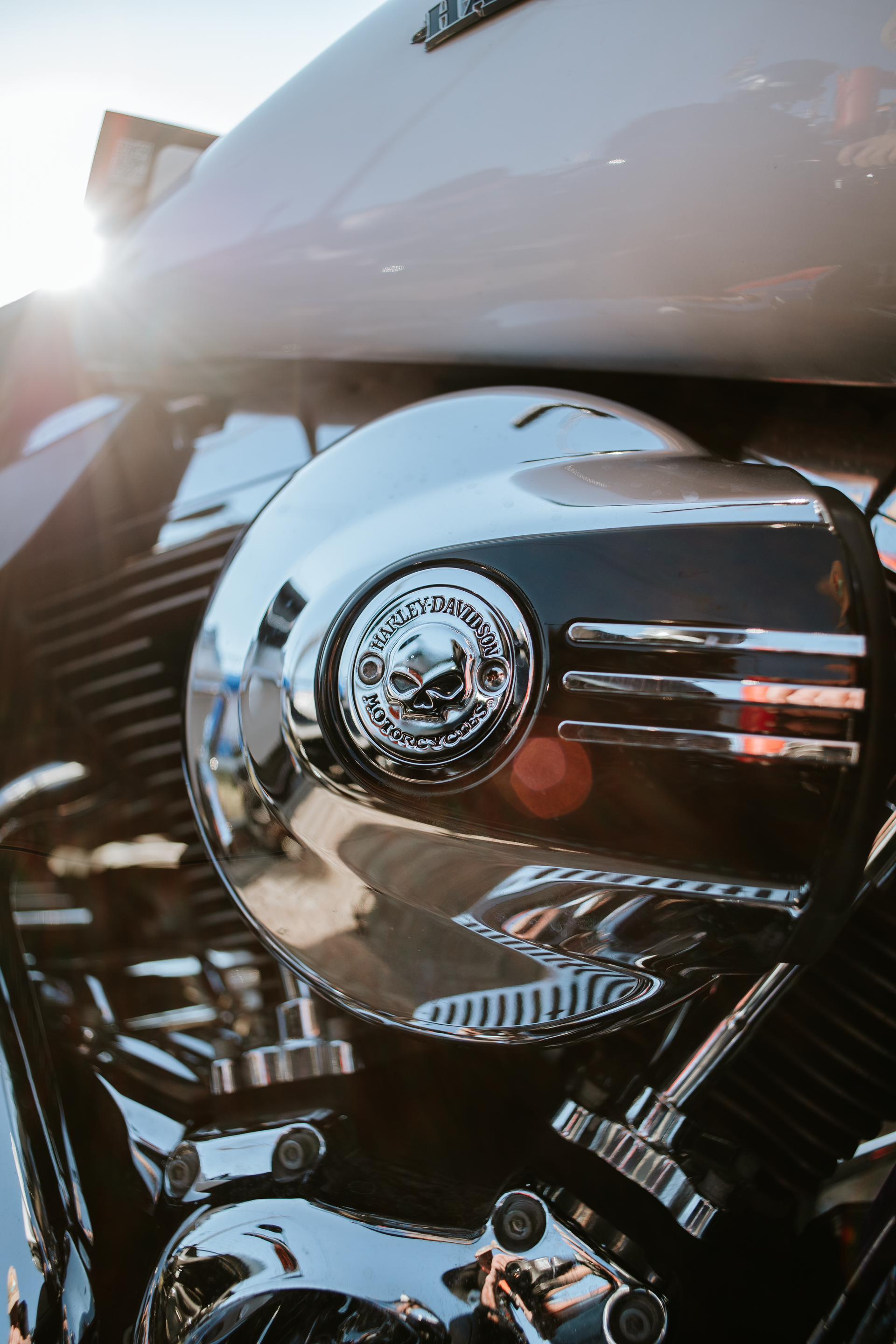 Chrome motorcycle engine with sun glare and black-and-silver detailing