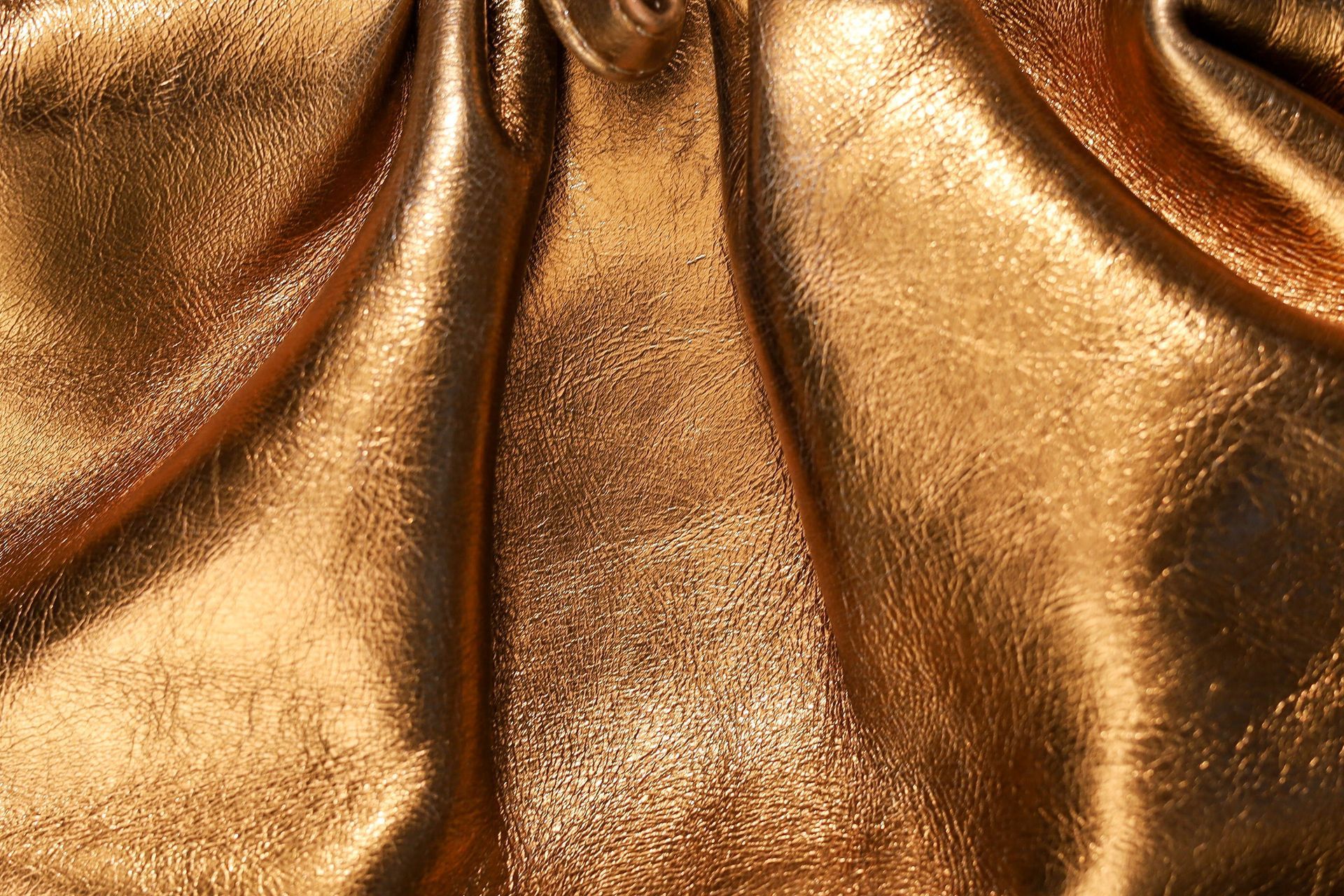 Shimmering bronze fabric with gathered folds and a metallic sheen