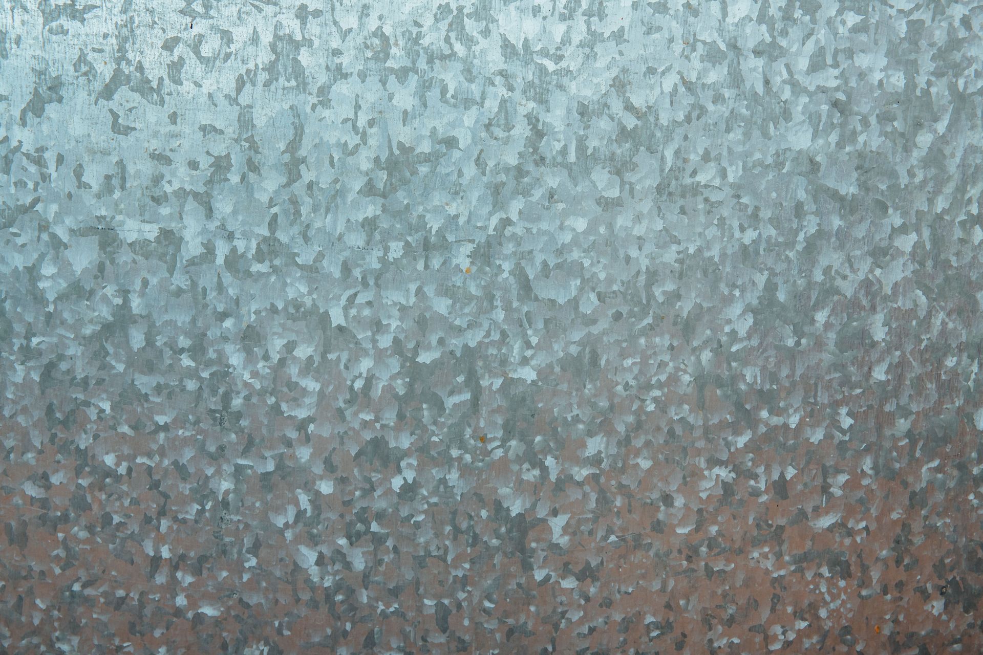 Close-up of a frosted, textured surface in pale blue-gray and brown tones