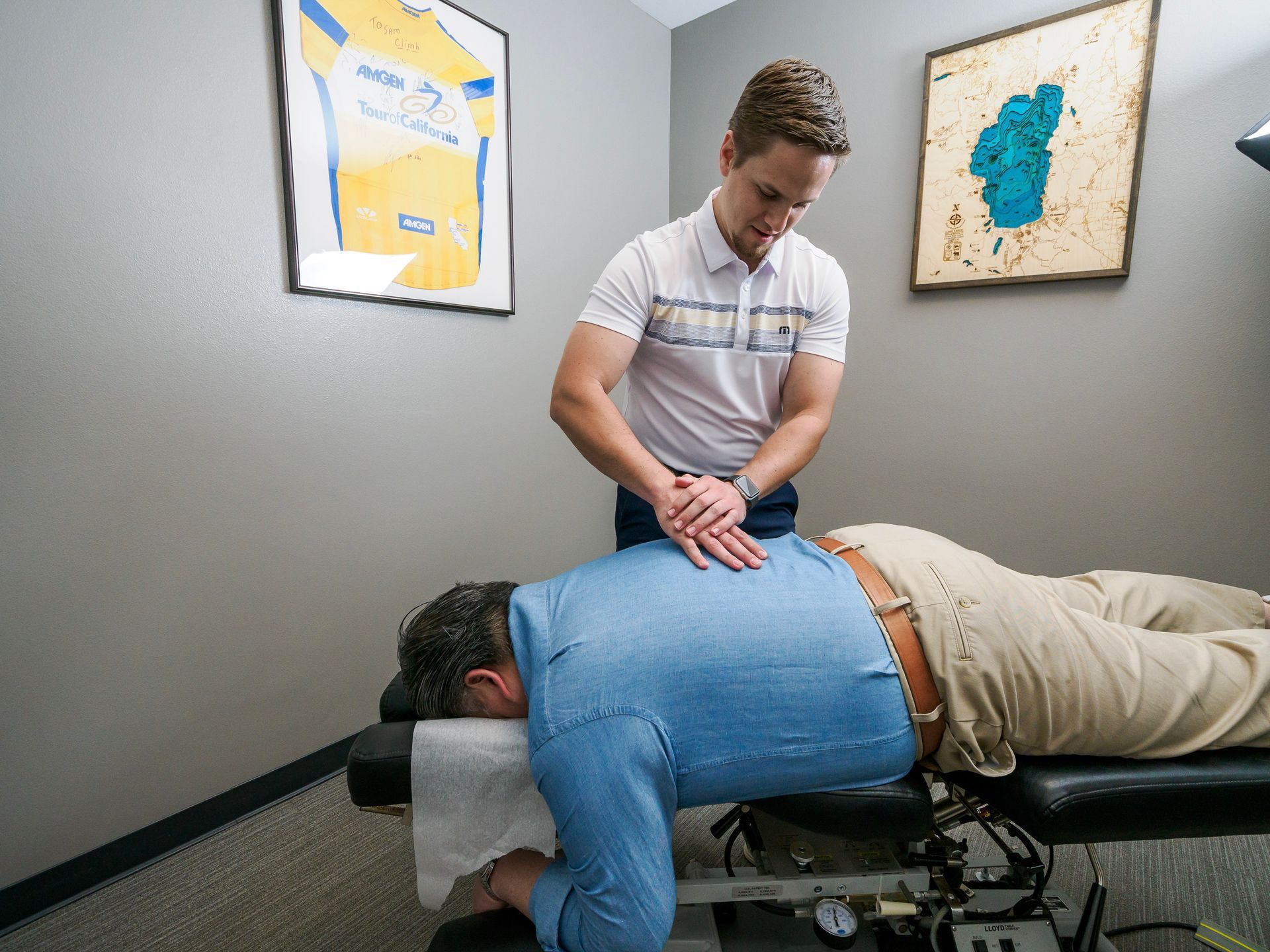 A man is laying on a table getting a chiropractic treatment.