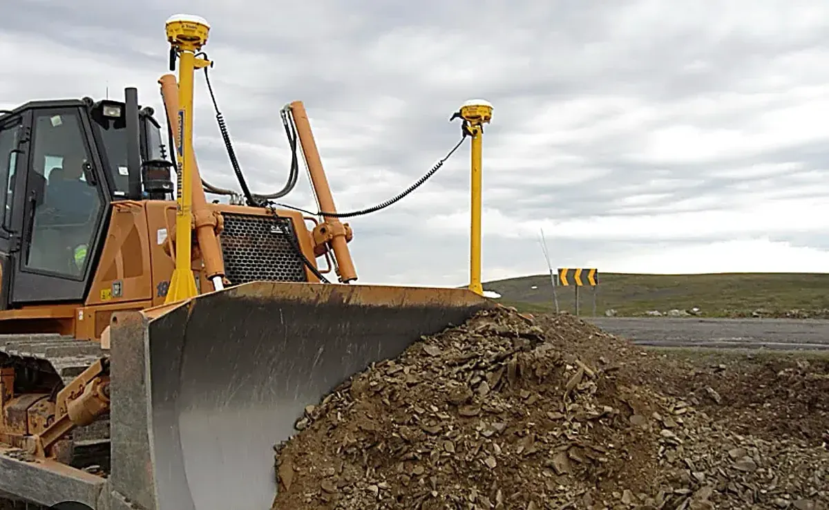 Bulldozer with GPS grade control grading a residential house pad