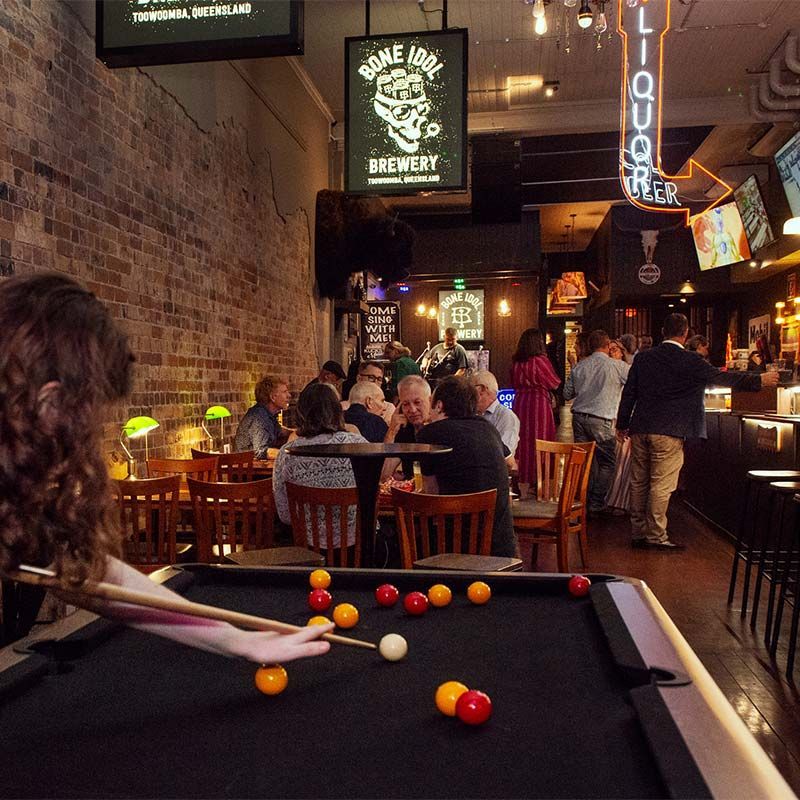 PLAYING POOL AT A POOL TABLE