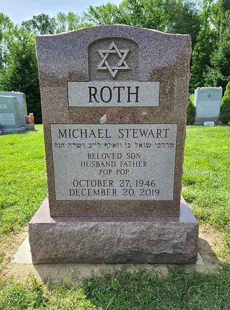 Gray granite Jewish gravestone with Star of David, labeled Roth and Michael Stewart in a cemetery.