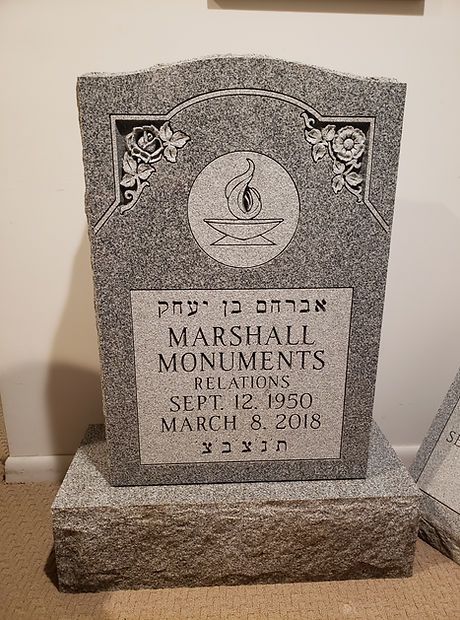 Gray memorial headstone with Hebrew inscription and Masonic emblem, dated March 8, 2018