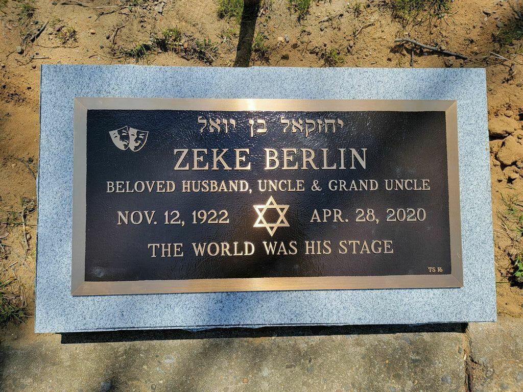 Black memorial plaque for Zeke Berlin with dates and Star of David on a stone base.