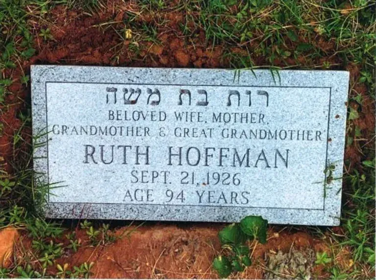 Ruth Hoffman grave marker with Hebrew inscription, surrounded by grass and red soil