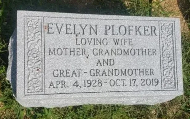 Gravestone for Evelyn Plofker, bordered in stone, inscribed “Loving Wife, Mother, Grandmother and Great-Grandmother.”
