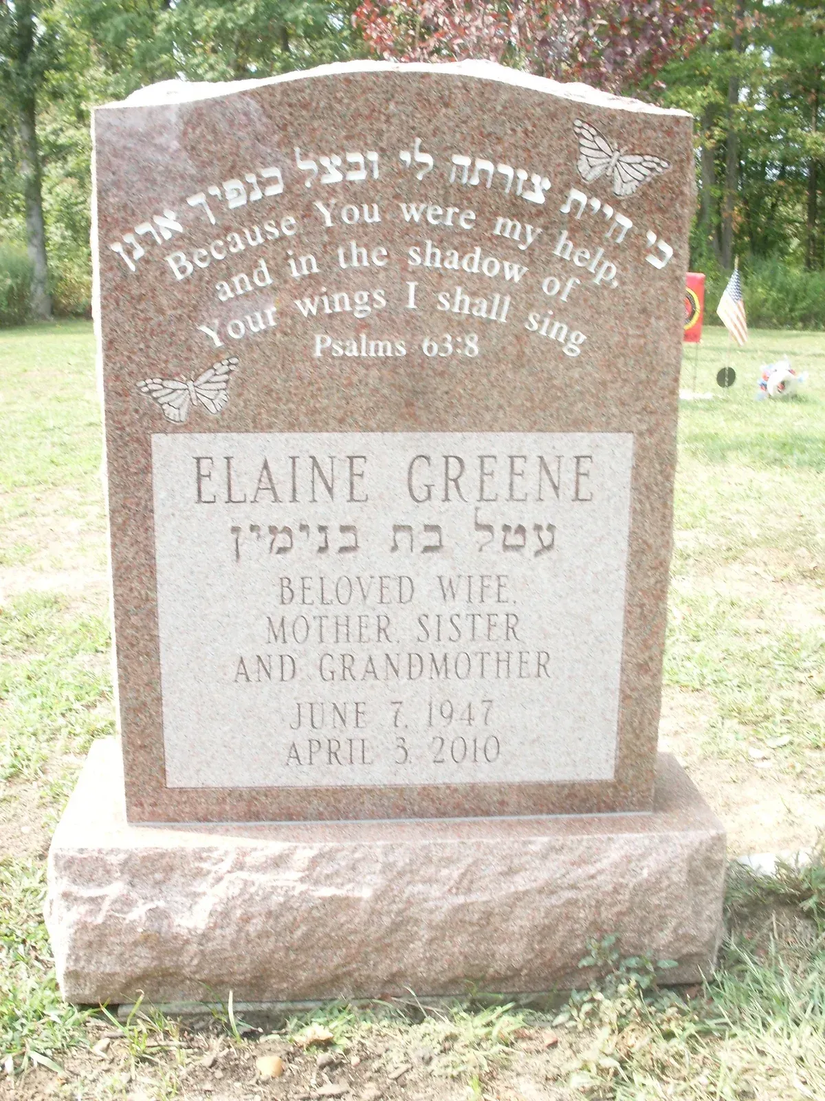 Two-tier gravestone in a cemetery, with engraved Bible verses and the name Elaine Greene.