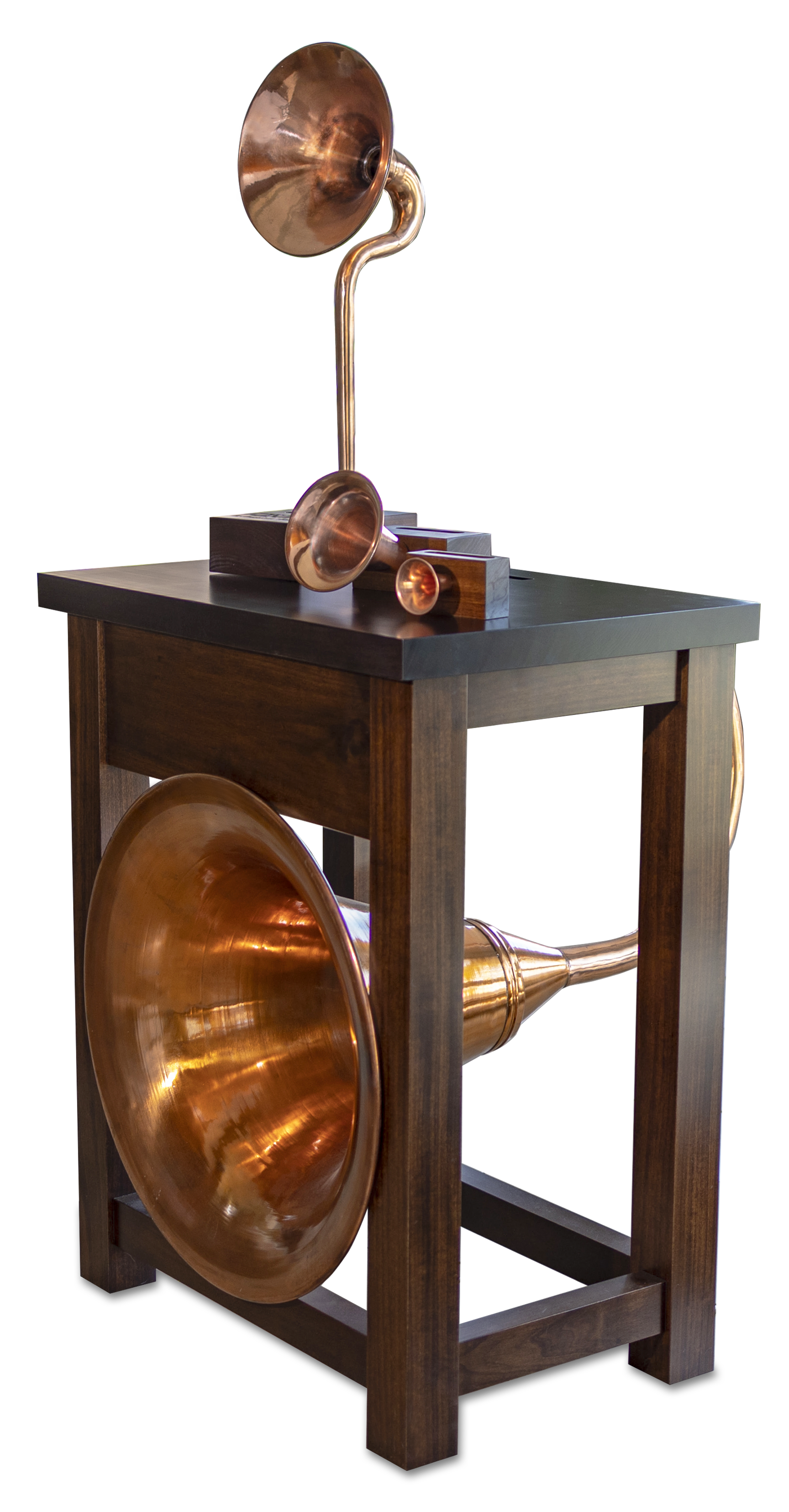 A copper phonograph is sitting on top of a wooden table.