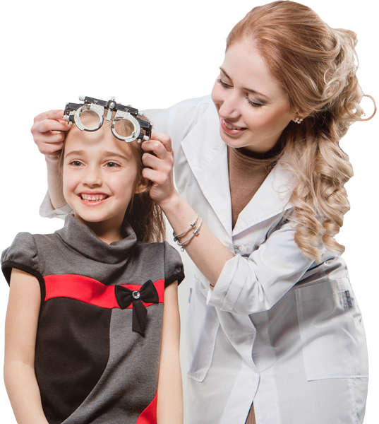 Optometrist fitting a young girl with a trial frame for an eye exam; the girl smiles.